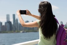 Young Woman Taking A Photograph From The Ferry