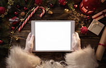 Close Up Of Santa Claus Hands Holding Blank Digital Tablet With Copy Space