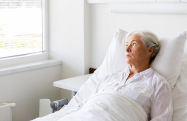 Sticker - sad senior woman lying on bed at hospital ward