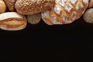 Wall Mural - Bakery concept. Plenty of bread background isolated on balck