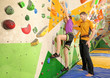 © Africa Studio - Little girl with trainer in climbing gym
