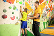 © Africa Studio - Little boy with trainer in climbing gym