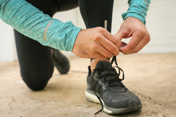  Sportsman tying shoelaces.
