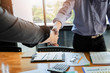 © skarie - Business people shaking hands finishing up a meeting. Two confident businessman shaking hands during a meeting in the office, success, dealing, greeting and partner concept.