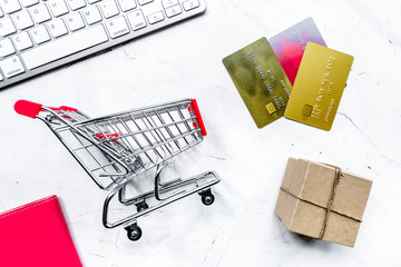 office desk with trolley and cards for online buying on light ba