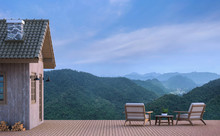Cabin House With Mountain View 3d Rendering Image.There Are Wood Floor.Furnished With Fabric And Wooden Furniture. There Are Wooden Railing Overlooking The Surrounding Nature And Mountain