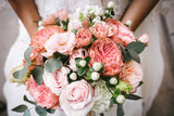 Fototapeta Kwiaty - Bride with bouquet, closeup