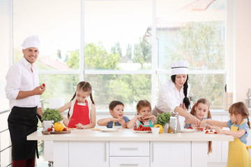 Poster - Two chefs and group of children during cooking classes