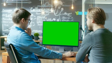 Poster - Two Office Employees Have Project Related Discussion, on the Desk Stands Personal Computer with Mock-up Green Screen. They Work in the Creative Office Environment. RED EPIC-W 8K Camera.
