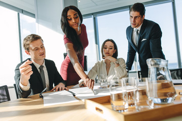 Wall Mural - Businesswoman presenting to colleagues at a meeting