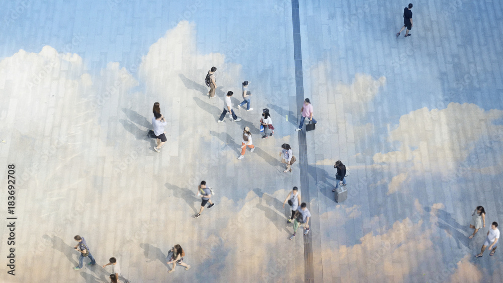top aerial view people walk on the pedestrian city street walkway on pavement concrete reflect cloud and blue sky.
