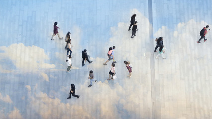top aerial view people walk on the pedestrian city street walkway on pavement concrete reflect cloud and blue sky.
