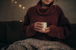 Woman having coffee in winter at home