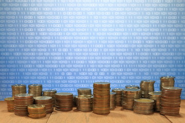 Wall Mural - coin chart pile and blue binary coding computer screen selective focus