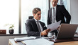 © Jacob Lund - Corporate business people reading papers in office