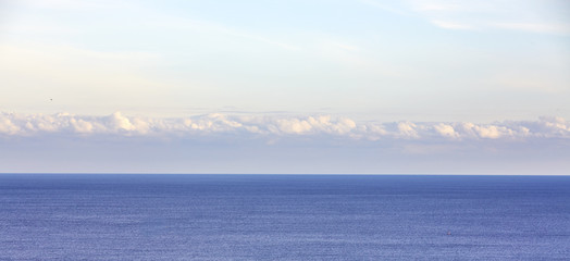 Blue sea on sky background. Beautiful blue sea against the blue sky. Mediterranean Sea.