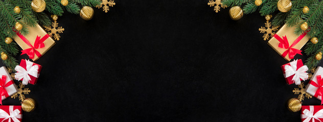 Wall Mural - Christmas gift boxes and shiny golden decorating ornaments on blackboard background