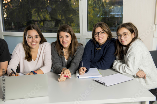 Fotografía group of young male and female teenager university students at school sitting on