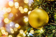 Beautiful Christmas-tree Decorated With Gold Bauble And Bokeh Background.