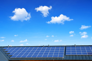 Wall Mural - solar energy panel on the roof of the house in the background blue sky. the concept of ecological ho