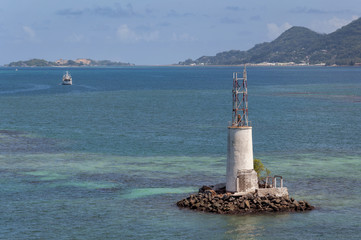 Old lighthouse in the light blue water.