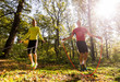 Handsome young men wearing sportswear and exercising in forest at mountain during autumn