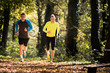Handsome young men wearing sportswear and running in forest at mountain during autumn