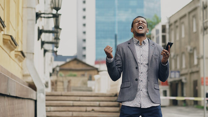 African american joyful businessman happy after talking phone about his new career