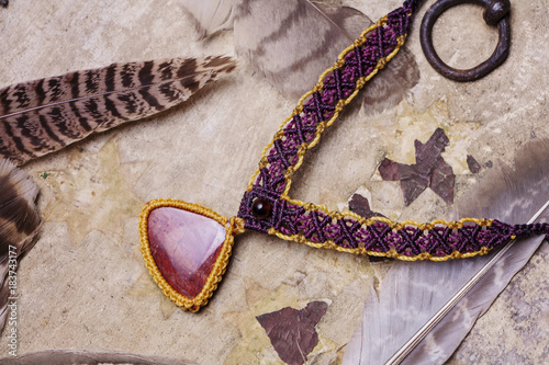 Fotografie, Obraz Natural gemstone handmade macrame meterial necklace with wild feather background