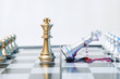 A conceptual photo with chess pieces and blood on a chessboard. Business, law or political concept, which could represent war of corporations, geopolitical situation and so on. Selective focus.