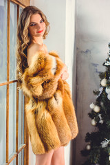 gorgeous woman in fox fur at christmas winter time. sexy beautiful thin woman in pretty fur coat at 