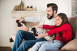 © LIGHTFIELD STUDIOS - happy father and daughter playing video game at home