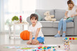© Africa Studio - Little boy painting while sitting on floor indoors