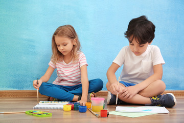 cute little children painting at home