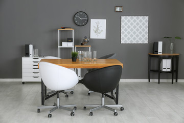 Canvas Print - Modern office interior with black and white armchairs