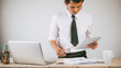 © nikomsolftwaer - Business man working at office with laptop and documents on his desk