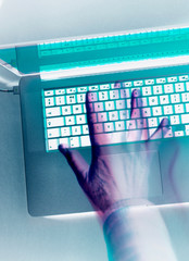 Cyber crime, hacker attacking a computer laptop with a virus