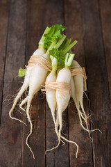 White organic radishes on the wooden table