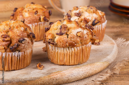 Fotografie, Obraz Golden Banana Nut Muffins on a Wooden Platter