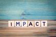 impact - name from wooden letters. Office desk, informative and communication background.