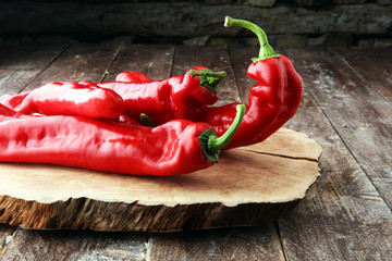 fresh and tasty red bell peppers on wooden background