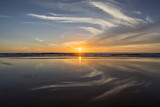 Fototapeta Pomosty - Sun setting at beach at low tide in San Diego, California
