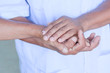 © weerachaiphoto - Hand of woman touching senior man in clinic