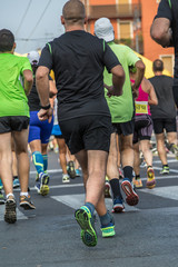 Wall Mural - People Running in City Marathon: Rear View