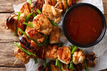 Wall Mural - Chicken kebabs with green onions in a spicy sauce - Dakkochi close-up. Horizontal top view
