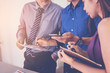 © Panumas - Business people meeting to discuss the situation on the market. Data in smart phone.