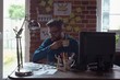© Wavebreak Media - Man looking at photos while having cup of coffee