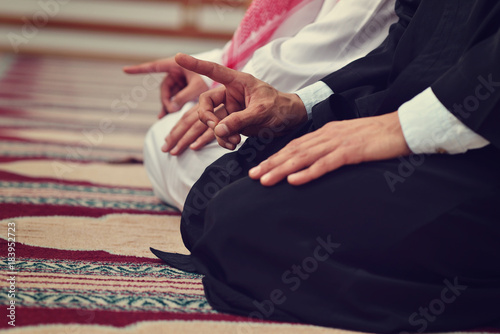 Cuadros en Lienzo Two religious muslim man praying together inside the mosque