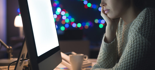 Wall Mural - Woman using a computer at home