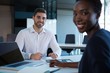 © WavebreakMediaMicro - Portrait of smiling executives sitting at desk